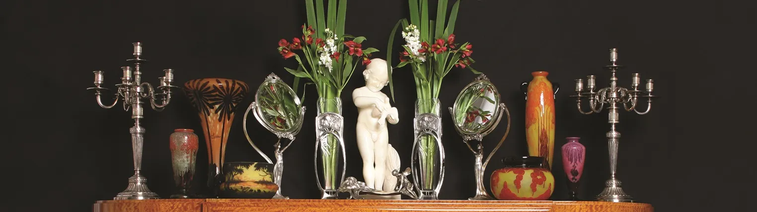 Antique candelabras surrounded by floral decorations and vases